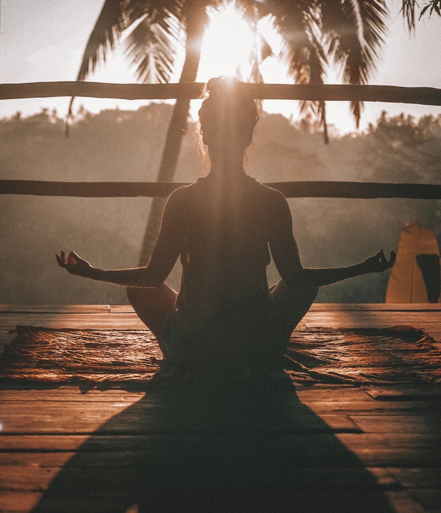 A student in a seated stretch during morning yoga practice at Hertford Yoga